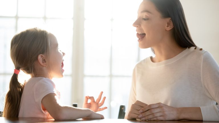 child practising to communicate and pronounciate words