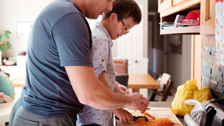 child with mental health issues completing a task with his father