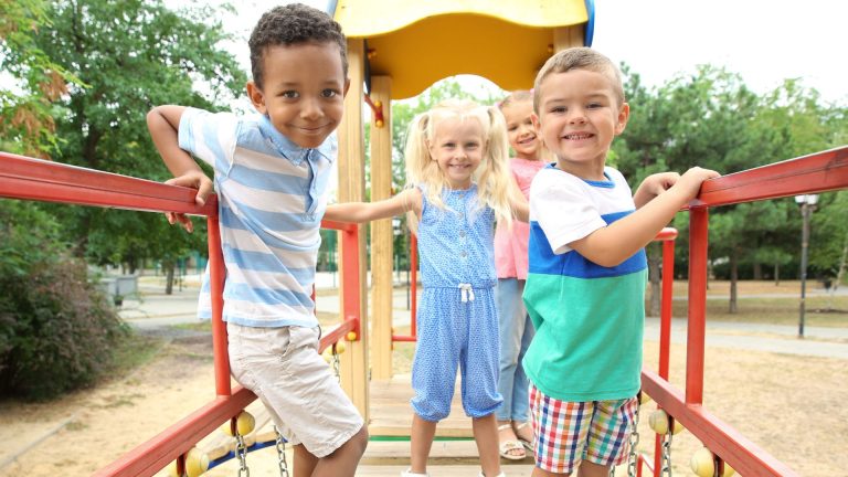 children playing well and happily together on a perk