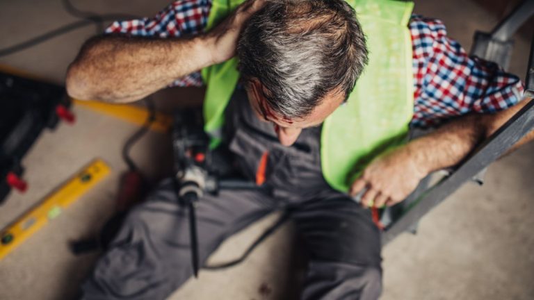 man suffering a brain injury at work